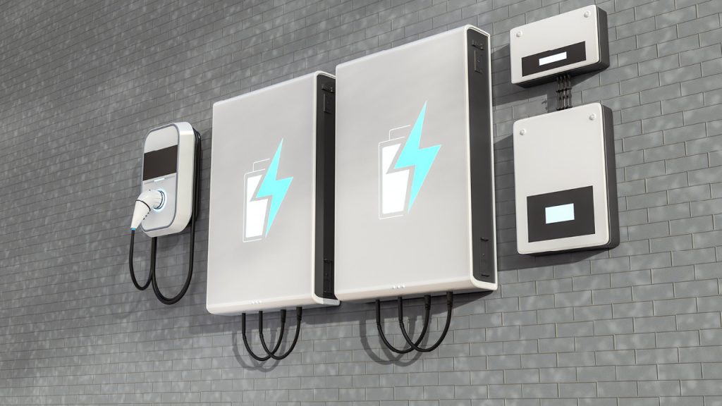 Electric vehicle charging station with two wall-mounted units, cables, and a charging plug on a gray brick wall, featuring a turquoise lightning bolt logo.