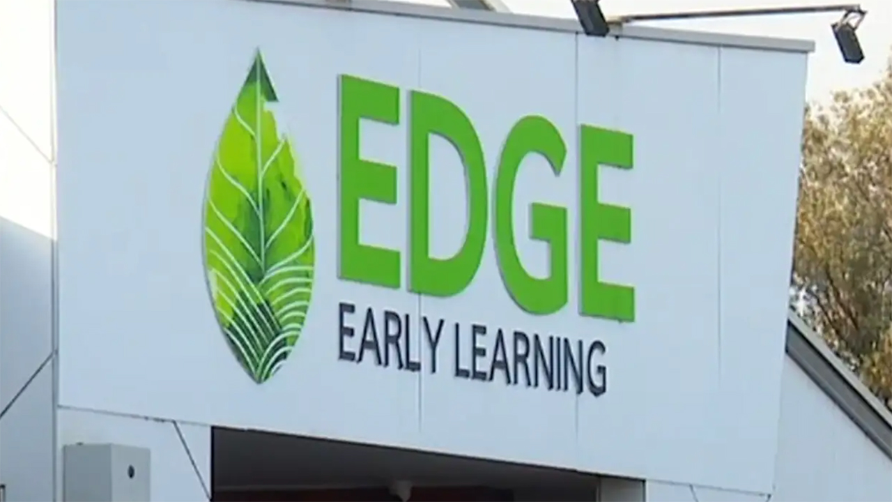 Sign on building reading 'EDGE Early Learning' with a bright green logo leaf on the left side.