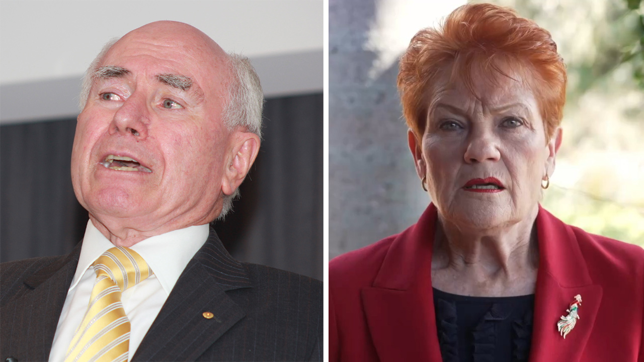 Two senior adults: left, a man in a dark pinstripe suit and yellow striped tie speaking; right, a woman with short red hair in a red blazer looking at the camera.