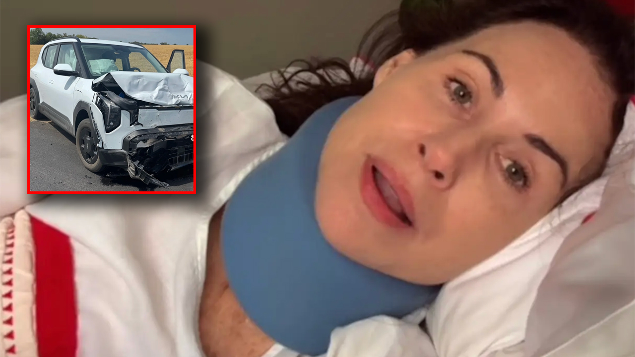 Woman in bed wearing a blue neck brace, appearing injured or recovering after a crash; inset shows a white SUV with major front-end damage from a collision on a road.