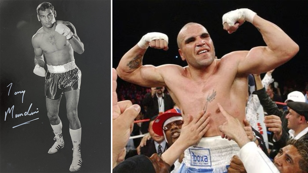 Black-and-white photo of a male boxer in trunks and gloves posing with one fist raised.